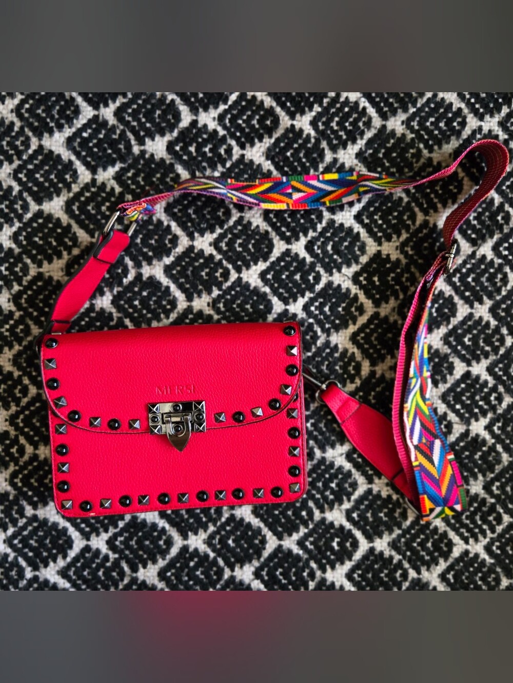 MERSI's coveted Ruby Red Studded Crossbody Bag with Multicolor Geo Strap